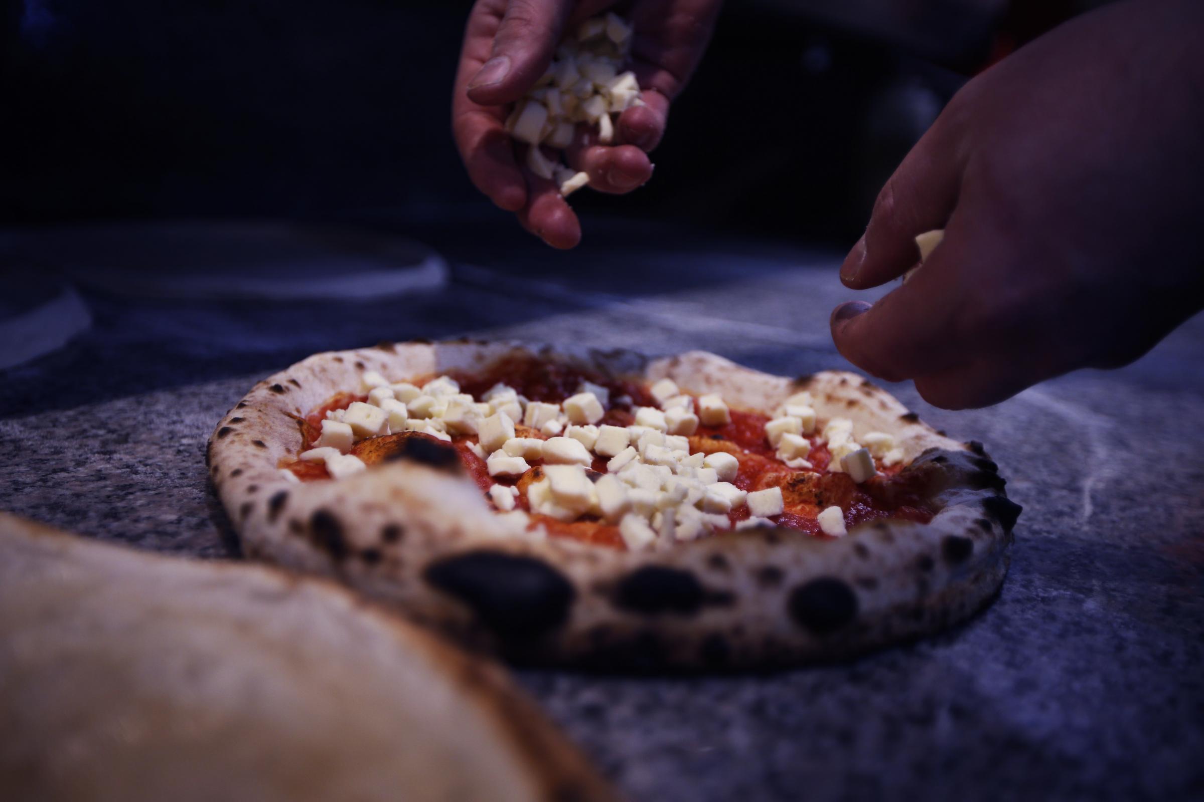 The Up in Arms pub has started producing pizzas you can bake at home. Pizza Chef Thomas Curtis is pictured with his creations. Picture by Ed Nix