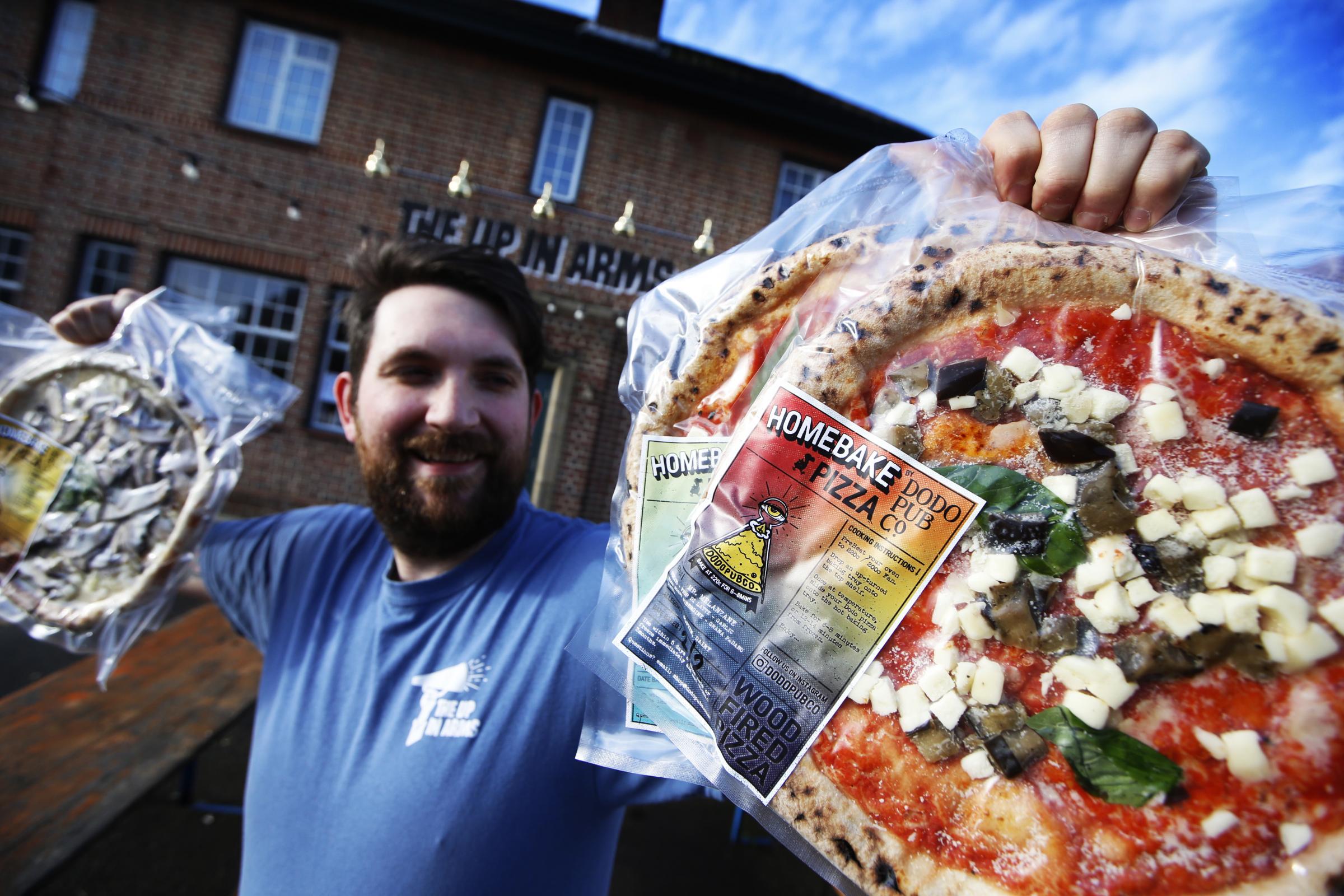 Pizza Chef Thomas Curtis with the finished products